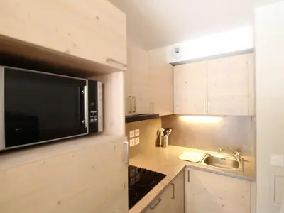a kitchen with a microwave and a sink at Flaine: 4P au pied des pistes, piscine, parking, 8 pers - FR-1-687-15 in Arâches-la-Frasse