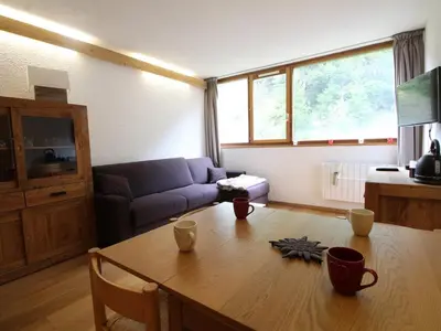 a living room with a table and a couch at Studio rénové 4 pers, Résidence Andromède, Flaine Forêt, à 300m des pistes et 140m des commerces - FR-1-687-26 in Arâches-la-Frasse