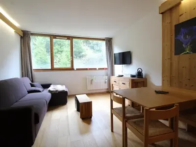 a living room with a couch and a table at Studio rénové 4 pers, Résidence Andromède, Flaine Forêt, à 300m des pistes et 140m des commerces - FR-1-687-26 in Arâches-la-Frasse
