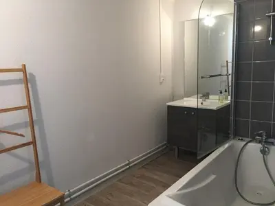 a bathroom with a tub and a sink and a mirror at Appartement 3 pièces pour 6 personnes à 350m des pistes – Résidence Petite Ourse, Flaine Forêt - FR-1-687-16 in Arâches-la-Frasse