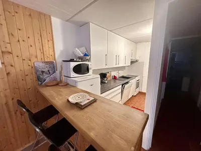 a small kitchen with a table and a microwave at Appartement Rénové - 2 Pièces, 6 Pers, Pied des Pistes - Résidence Cassiopée, Flaine Forum - FR-1-687-32 in Arâches-la-Frasse