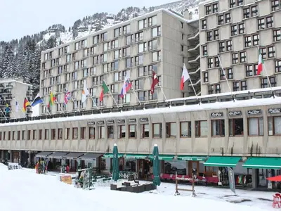 a building with a bunch of flags on top of it at Appartement Rénové - 2 Pièces, 6 Pers, Pied des Pistes - Résidence Cassiopée, Flaine Forum - FR-1-687-32 in Arâches-la-Frasse