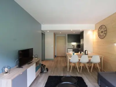 a living room with a table and a dining room at Appartement 3 pièces pour 8 personnes aux pieds des pistes à Flaine - FR-1-687-44 in Arâches-la-Frasse