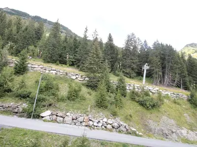 a road with a bunch of rocks and trees at Appartement 3 pièces pour 8 personnes aux pieds des pistes à Flaine - FR-1-687-44 in Arâches-la-Frasse