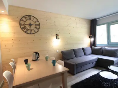 a living room with a couch and a table at Appartement 3 pièces pour 8 personnes aux pieds des pistes à Flaine - FR-1-687-44 in Arâches-la-Frasse