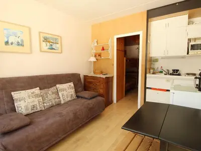 a living room with a brown couch and a kitchen at Studio confortable 4 pers, au pied des pistes de Flaine avec balcon - FR-1-687-28 in Arâches-la-Frasse