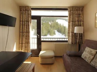 a living room with a couch and a large window at Studio confortable 4 pers, au pied des pistes de Flaine avec balcon - FR-1-687-28 in Arâches-la-Frasse