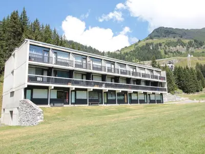 a large building with a grass field in front of it at Studio confortable 4 pers, au pied des pistes de Flaine avec balcon - FR-1-687-28 in Arâches-la-Frasse