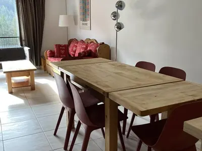 a dining room with a wooden table and chairs at Appartement 3 pièces rénové, 8 pers, proche pistes, Wifi - FR-1-687-23 in Arâches-la-Frasse