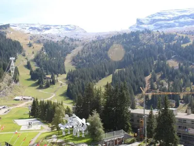 a view of a mountain with trees and a building at Appartement 3 pièces rénové, 8 pers, proche pistes, Wifi - FR-1-687-23 in Arâches-la-Frasse
