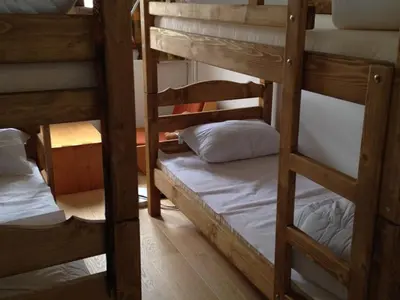 a room with three bunk beds in a room at Appartement 3 pièces rénové, 8 pers, proche pistes, Wifi - FR-1-687-23 in Arâches-la-Frasse