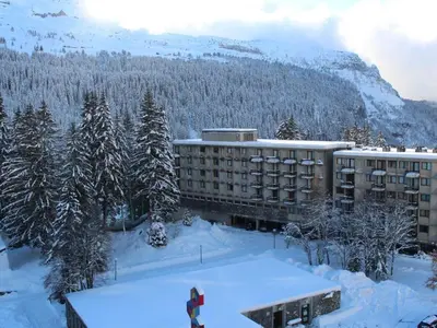 a person riding a snowboard in the snow in front of a hotel at Appartement 3 pièces rénové, 8 pers, proche pistes, Wifi - FR-1-687-23 in Arâches-la-Frasse