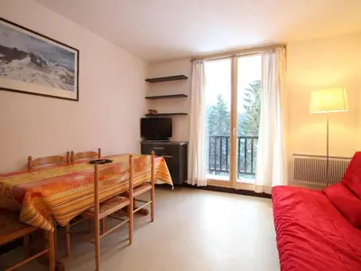 a living room with a table and a couch at Studio rénové à Flaine Forêt, résidence Sirius, à 500m des pistes – 5 couchages - FR-1-687-17 in Arâches-la-Frasse