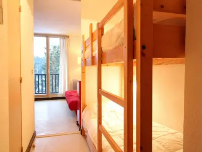 a room with two bunk beds and a balcony at Studio rénové à Flaine Forêt, résidence Sirius, à 500m des pistes – 5 couchages - FR-1-687-17 in Arâches-la-Frasse