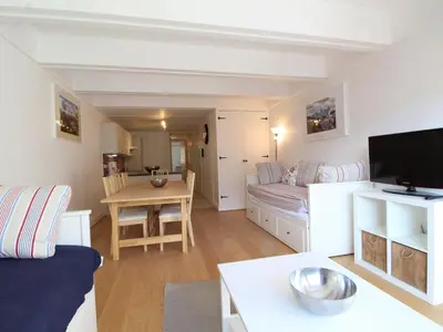 a small living room with a couch and a table at Appartement rénové 3 pièces, 8 pers, proche pistes et commerces - Flaine Forum - FR-1-687-39 in Arâches-la-Frasse
