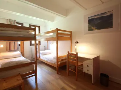 a bedroom with two bunk beds and a desk at Appartement rénové 3 pièces, 8 pers, proche pistes et commerces - Flaine Forum - FR-1-687-39 in Arâches-la-Frasse