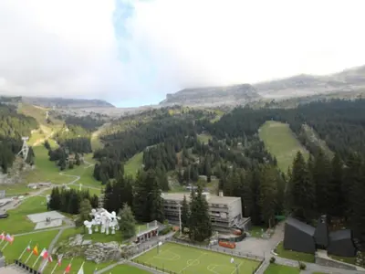 an aerial view of a park with a building and trees at Appartement rénové 3 pièces, 8 pers, proche pistes et commerces - Flaine Forum - FR-1-687-39 in Arâches-la-Frasse