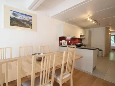 a kitchen and dining room with a wooden table and chairs at Appartement rénové 3 pièces, 8 pers, proche pistes et commerces - Flaine Forum - FR-1-687-39 in Arâches-la-Frasse