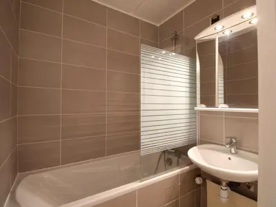 a bathroom with a tub and a sink and a mirror at Appartement rénové 3 pièces, 8 pers, proche pistes et commerces - Flaine Forum - FR-1-687-39 in Arâches-la-Frasse