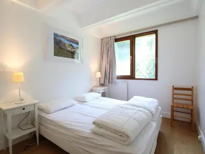 a white bedroom with a bed and a window at Appartement rénové 3 pièces, 8 pers, proche pistes et commerces - Flaine Forum - FR-1-687-39 in Arâches-la-Frasse