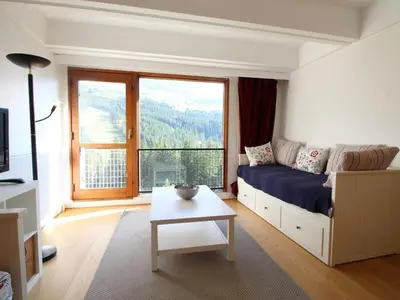 a living room with a bed and a large window at Appartement rénové 3 pièces, 8 pers, proche pistes et commerces - Flaine Forum - FR-1-687-39 in Arâches-la-Frasse