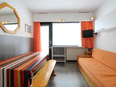 a living room with two benches and a window at Studio pour 4 personnes, résidence Bellatrix, Flaine Front de Neige, accès direct aux pistes - FR-1-687-45 in Arâches-la-Frasse