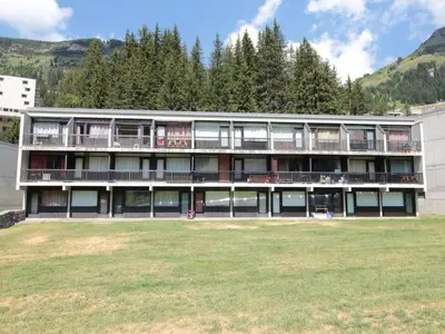 a large building with a grass field in front of it at Studio pour 4 personnes, résidence Bellatrix, Flaine Front de Neige, accès direct aux pistes - FR-1-687-45 in Arâches-la-Frasse