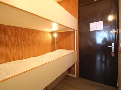 a small room with a bed in a wooden wall at Studio pour 4 personnes, résidence Bellatrix, Flaine Front de Neige, accès direct aux pistes - FR-1-687-45 in Arâches-la-Frasse