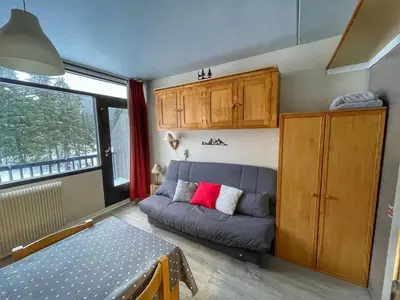 a living room with a couch and a window at Studio pour 4 pers à Flaine, au pied des pistes - FR-1-687-60 in Arâches-la-Frasse