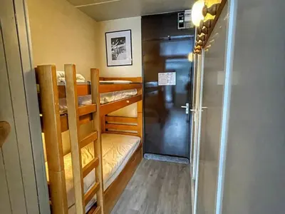 a room with two bunk beds and a door at Studio pour 4 pers à Flaine, au pied des pistes - FR-1-687-60 in Arâches-la-Frasse