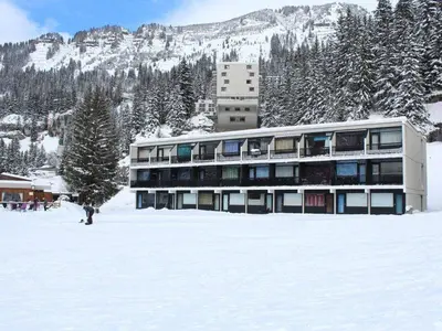 a building in the snow in front of a mountain at Studio pour 4 pers à Flaine, au pied des pistes - FR-1-687-60 in Arâches-la-Frasse