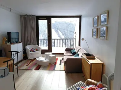 a living room with a couch and a balcony at Appartement 2 Pièces avec Balcon, Proche Pistes - FR-1-687-56 in Arâches-la-Frasse