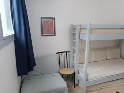 a bedroom with a bunk bed and a chair at Appartement 2 Pièces avec Balcon, Proche Pistes - FR-1-687-56 in Arâches-la-Frasse