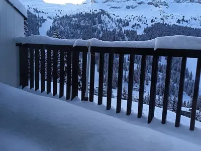 a snow covered railing with a view of a mountain at Appartement 2 Pièces avec Balcon, Proche Pistes - FR-1-687-56 in Arâches-la-Frasse