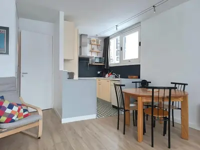 a kitchen and dining room with a table and chairs at Appartement 2 Pièces avec Balcon, Proche Pistes - FR-1-687-56 in Arâches-la-Frasse