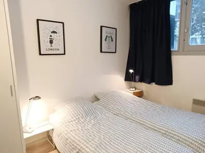 a bedroom with a bed and two pictures on the wall at Appartement 2 Pièces avec Balcon, Proche Pistes - FR-1-687-56 in Arâches-la-Frasse