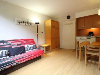 a living room with a red couch and a kitchen at Studio 4 pers, lave-vaisselle, proche pistes et commerces, navette gratuite - FR-1-687-47 in Arâches-la-Frasse