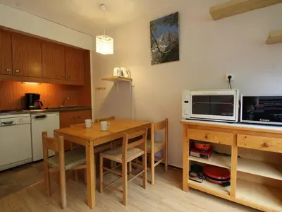a kitchen with a wooden table and a microwave at Studio 4 pers, lave-vaisselle, proche pistes et commerces, navette gratuite - FR-1-687-47 in Arâches-la-Frasse