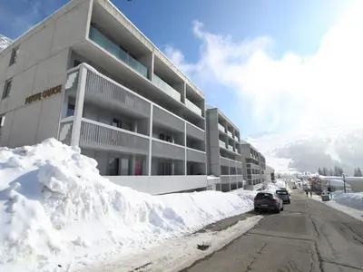 a snow covered street in front of a building at Appartement 2 pièces pour 5 pers. à Flaine Forêt, à 350m des pistes et proche des commerces - FR-1-687-34 in Arâches-la-Frasse