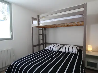 a bedroom with a bunk bed with black and white stripes at Appartement 2 pièces pour 5 pers. à Flaine Forêt, à 350m des pistes et proche des commerces - FR-1-687-34 in Arâches-la-Frasse
