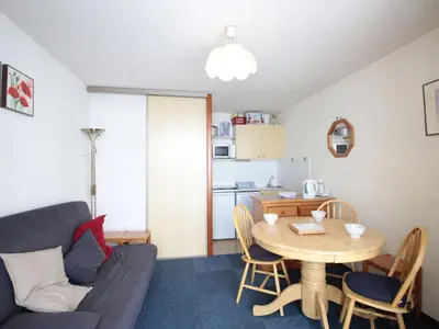a living room with a table and a kitchen at Studio Cabine 5 pers avec Balcon - Résidence Sagittaire, Flaine Forêt - FR-1-687-43 in Arâches-la-Frasse