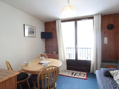 a living room with a wooden table and a dining room at Studio Cabine 5 pers avec Balcon - Résidence Sagittaire, Flaine Forêt - FR-1-687-43 in Arâches-la-Frasse