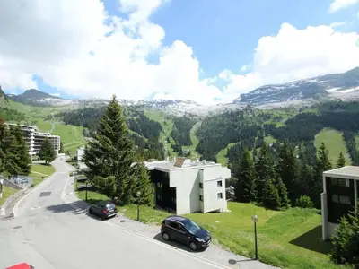 a road with cars parked on the side of a mountain at Studio 4 pers, proche pistes, animaux bienvenus - FR-1-687-37 in Arâches-la-Frasse