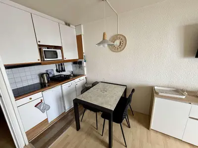a small kitchen with a table and a small kitchen with a counter at Studio 4 pers, proche pistes, animaux bienvenus - FR-1-687-37 in Arâches-la-Frasse