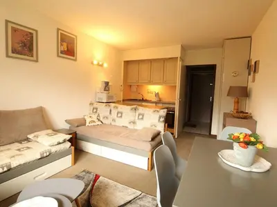 a small living room with a bed and a table at Appartement rénové 2 pièces pour 6 personnes avec balcon sud à 300m des pistes - Flaine Forêt - FR-1-687-48 in Arâches-la-Frasse