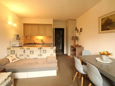 a living room with a bed and a kitchen at Appartement rénové 2 pièces pour 6 personnes avec balcon sud à 300m des pistes - Flaine Forêt - FR-1-687-48 in Arâches-la-Frasse
