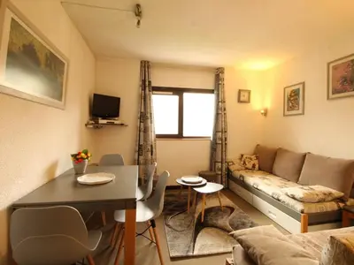 a living room with a couch and a table at Appartement rénové 2 pièces pour 6 personnes avec balcon sud à 300m des pistes - Flaine Forêt - FR-1-687-48 in Arâches-la-Frasse