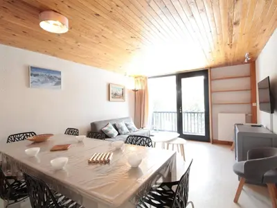 a living room with a table and a couch at Appartement 3 pièces pour 8 pers, au pied des pistes – Résidence Aldebaran, Flaine Forum - FR-1-687-57 in Arâches-la-Frasse