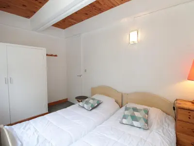 two beds in a room with white walls and wooden ceilings at Appartement 3 pièces pour 8 pers, au pied des pistes – Résidence Aldebaran, Flaine Forum - FR-1-687-57 in Arâches-la-Frasse
