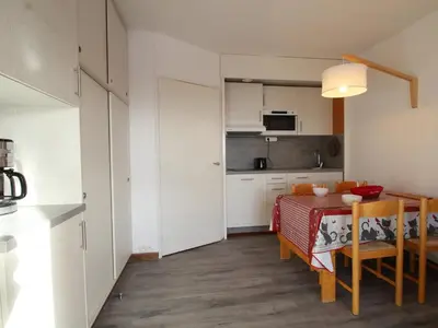 a kitchen and dining room with a table and chairs at Studio rénové 4 pers avec balcon sud, proche pistes et commerces, casier à skis, parking - FR-1-687-33 in Arâches-la-Frasse